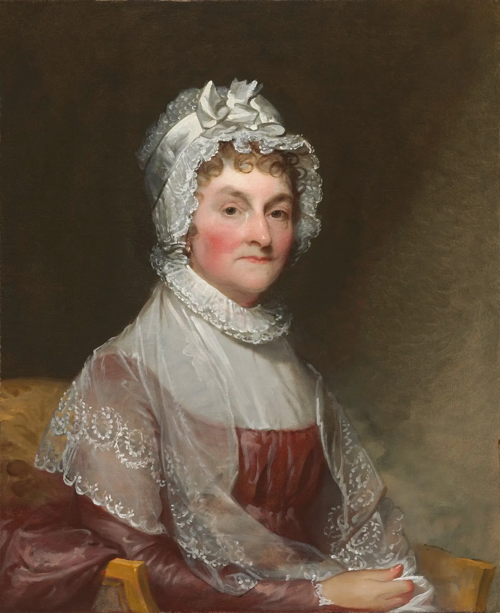Gilbert Stuart's portrait of Abigail Adams, seated in a white lace cap and shawl over a rose-colored gown, painted about 1810–1815